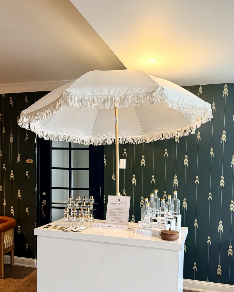 The Philly Scent Club cart with its white fringed umbrella, set up at a venue
