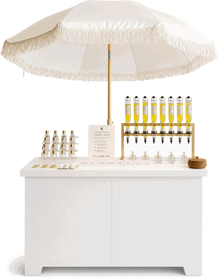 The Philly Scent Club mobile fragrance cart with gold dispensers and fringed umbrella